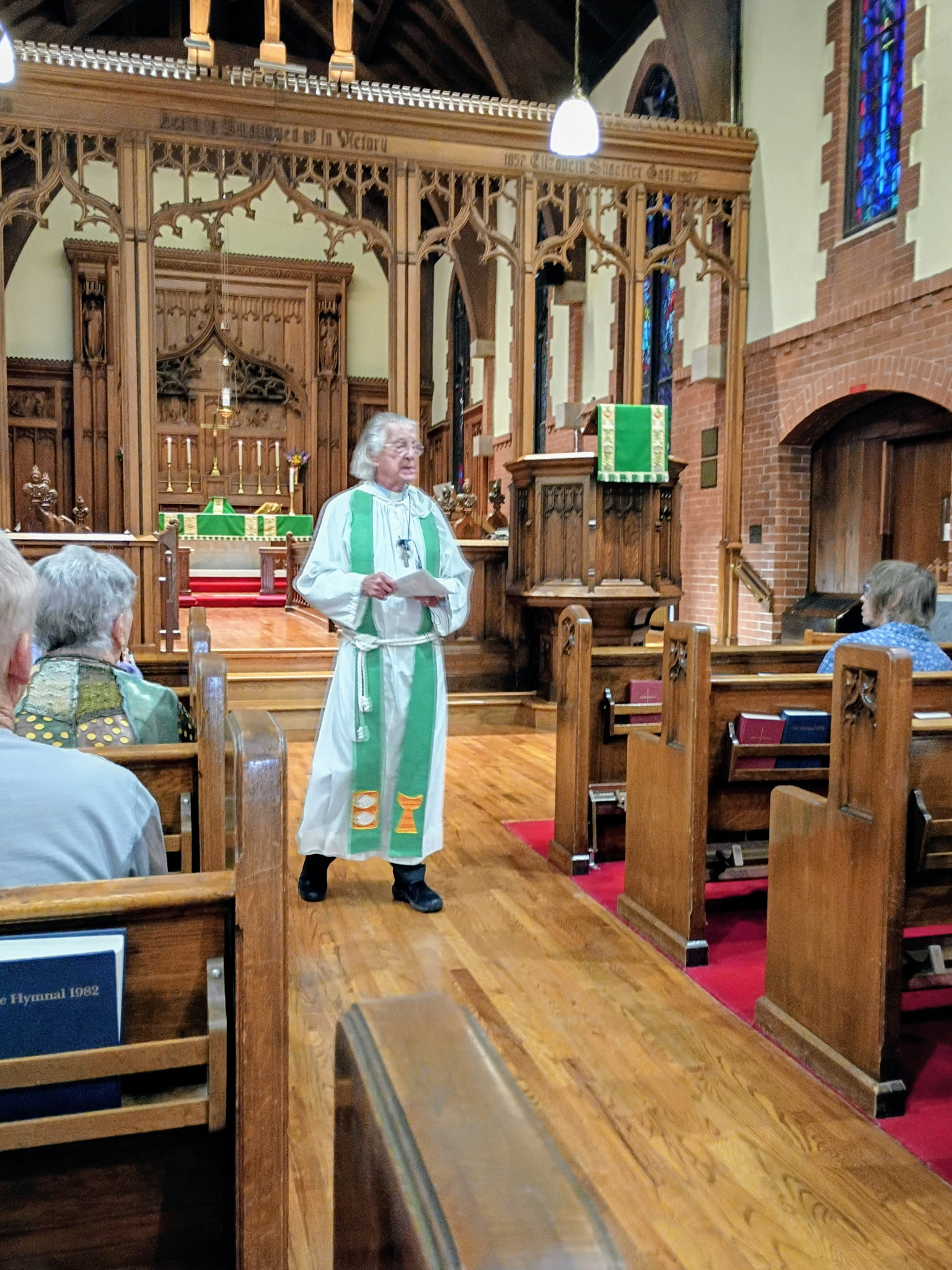 Wayne delivering a homily